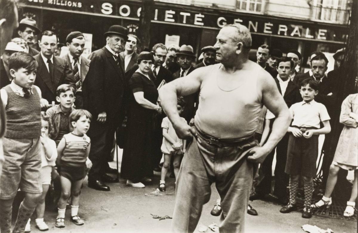 Weightlifter Yves Boulanger entertains the crowd in the Paris Street