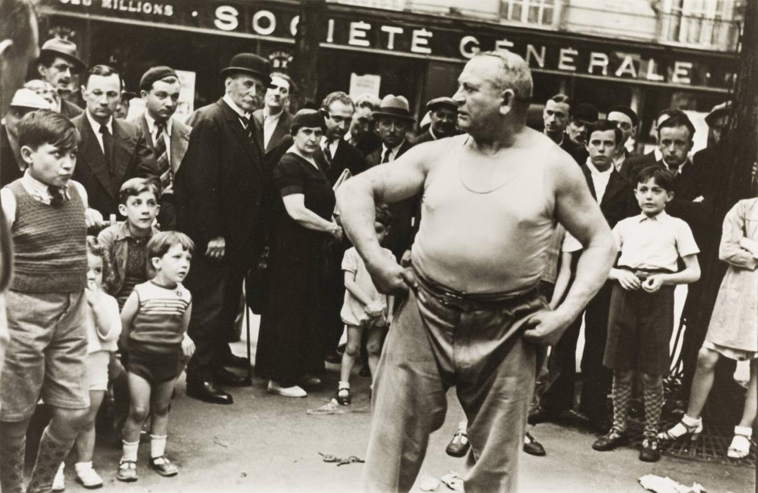 Weightlifter Yves Boulanger entertains the crowd in the Paris Street