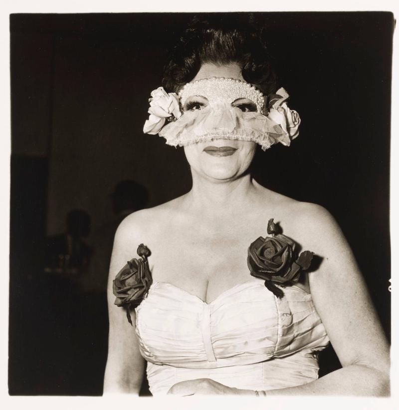 Lady at masked ball with two roses on her dress