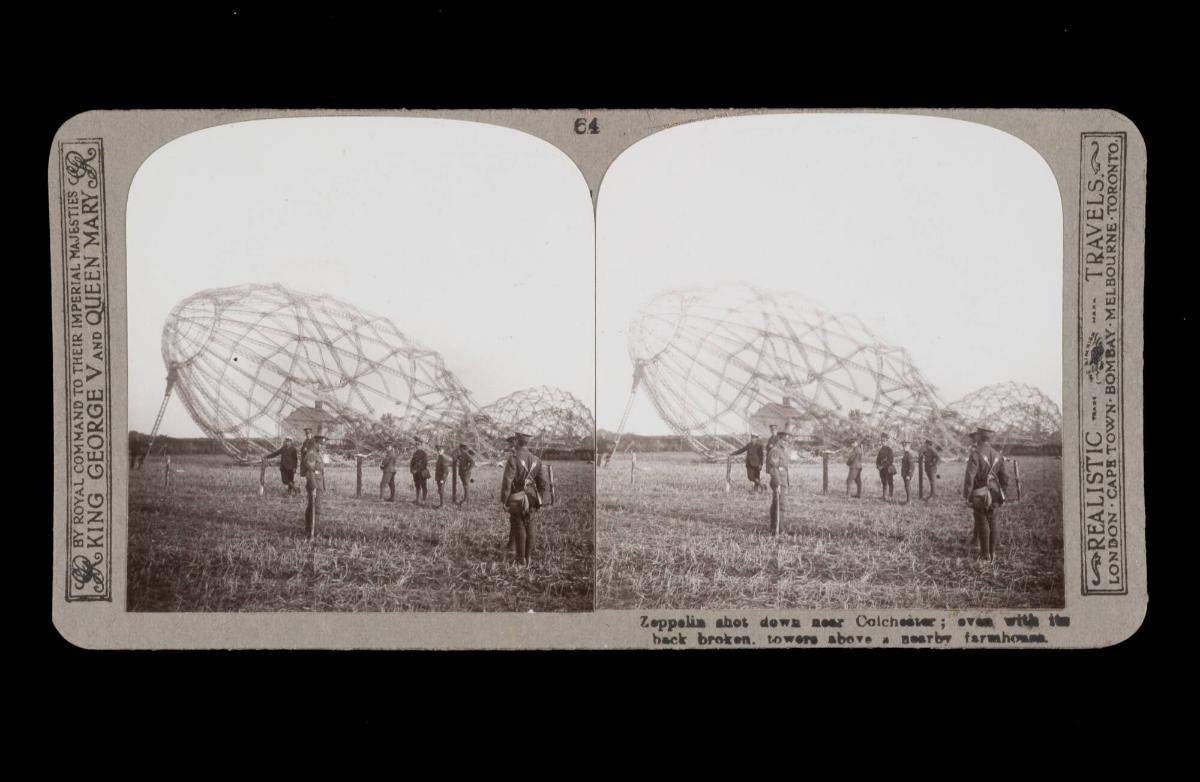 Zeppelin shot down near Colchester; even with the back broken. towers a nearby farmhouse. From the box The Great War
