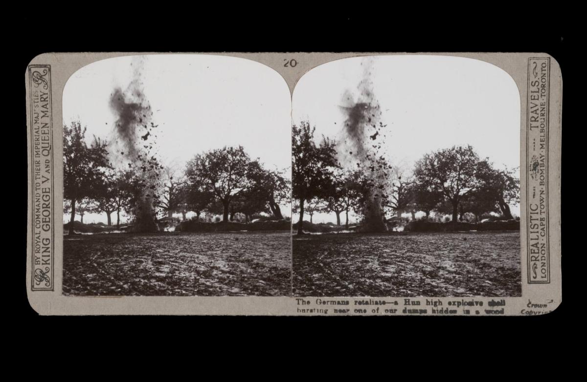 The German retaliate - a Hun high explosive shell bursting near one of our dumps hidden in the wood. From the box The Great War