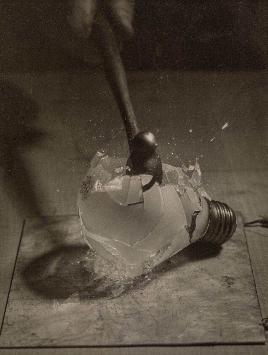 Hammer smashing an electric-light bulb