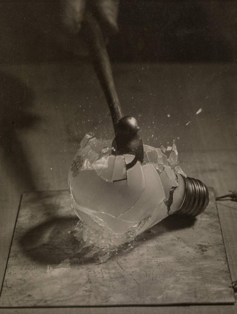Hammer smashing an electric-light bulb
